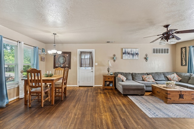 1321 S Lamar St, Weatherford, TX 76086 - living area with dark wood finished floors, a textured ceiling, a chandelier, and a ceiling fan