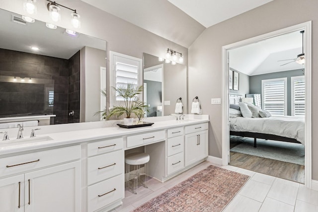 7709 Waterside, The Colony, TX 75056 - ensuite bathroom with lofted ceiling, double vanity, a ceiling fan, walk in shower, and tile patterned flooring