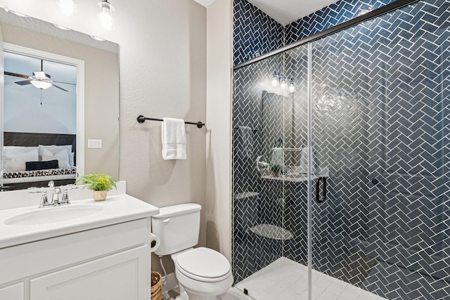 7709 Waterside, The Colony, TX 75056 - bathroom featuring ceiling fan, vanity, and a stall shower