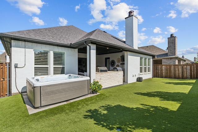 7709 Waterside, The Colony, TX 75056 - back of house with a hot tub, brick siding, a fenced backyard, and a shingled roof