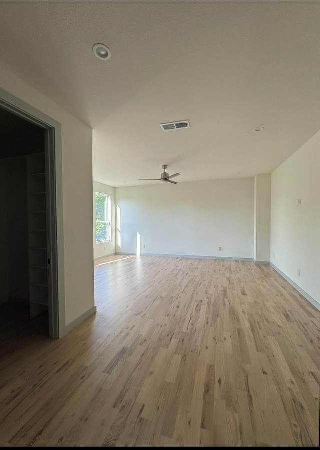 906 S Ewing Ave, Dallas, TX 75203 - unfurnished living room with light wood finished floors and a ceiling fan
