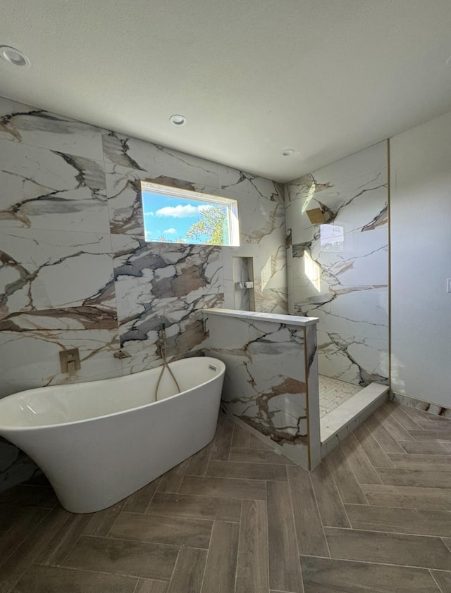 906 S Ewing Ave, Dallas, TX 75203 - bathroom with recessed lighting, a marble finish shower, and a freestanding bath