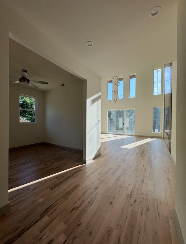 908 S Ewing Ave, Dallas, TX 75203 - unfurnished living room with wood finished floors and a ceiling fan