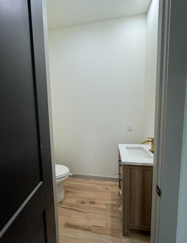 908 S Ewing Ave, Dallas, TX 75203 - half bathroom featuring vanity and wood finished floors