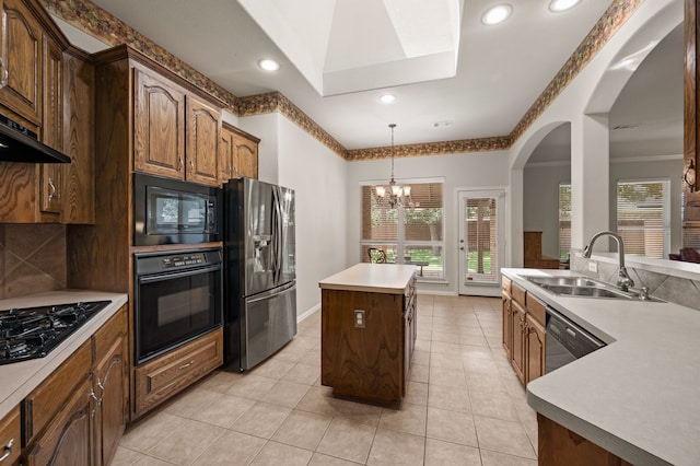103 Deer Ct, Mansfield, TX 76063 - kitchen featuring black appliances, a chandelier, a kitchen island, decorative light fixtures, and light countertops