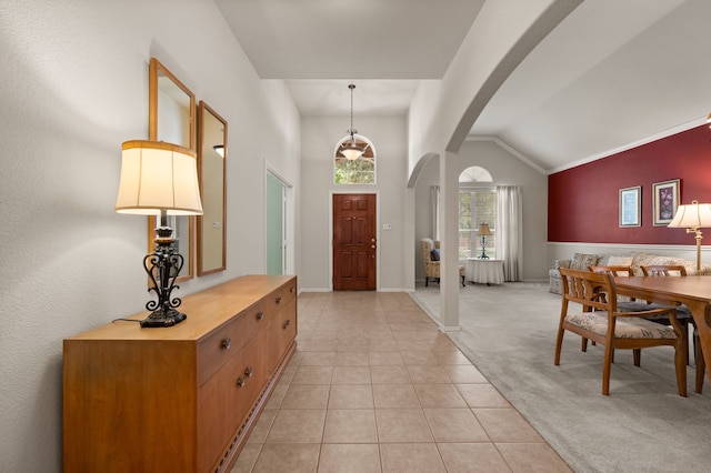 103 Deer Ct, Mansfield, TX 76063 - foyer featuring arched walkways, lofted ceiling, light tile patterned flooring, and light carpet