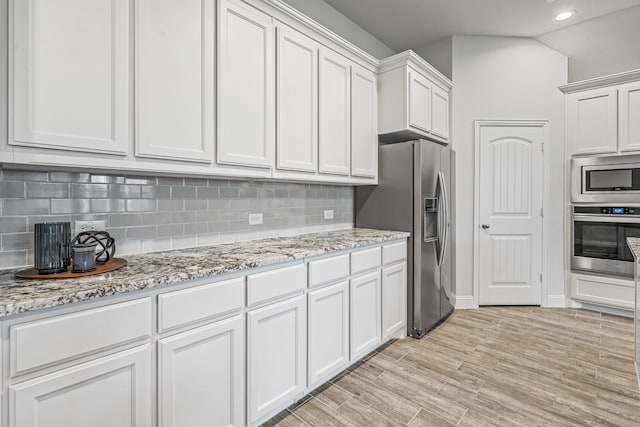 14840 Nightmist Rd, Aledo, TX 76008 - kitchen featuring stainless steel appliances, white cabinets, decorative backsplash, recessed lighting, and light stone countertops