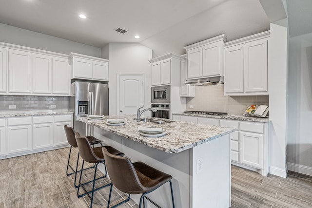 14840 Nightmist Rd, Aledo, TX 76008 - kitchen featuring stainless steel appliances, decorative backsplash, white cabinets, light wood-style floors, and recessed lighting