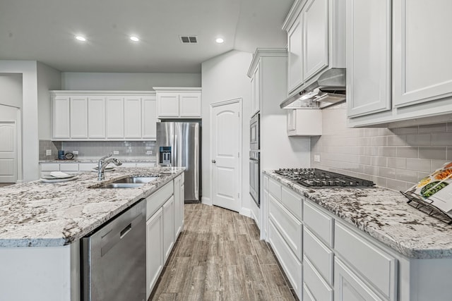 14840 Nightmist Rd, Aledo, TX 76008 - kitchen with stainless steel appliances, under cabinet range hood, tasteful backsplash, light wood-type flooring, and recessed lighting