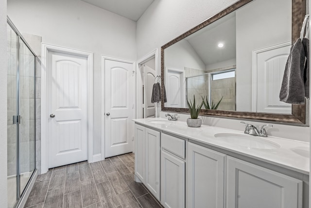 14840 Nightmist Rd, Aledo, TX 76008 - full bathroom featuring a shower stall, double vanity, lofted ceiling, and wood tiled floors