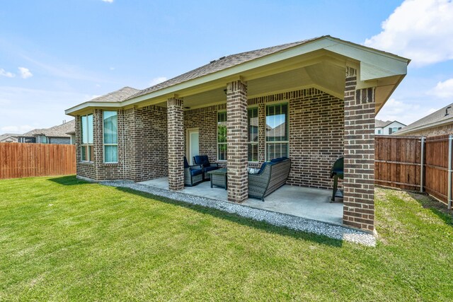 14840 Nightmist Rd, Aledo, TX 76008 - rear view of house with a fenced backyard, brick siding, a patio, and an outdoor living space