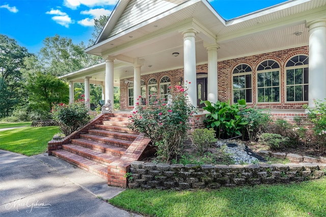 3669 Fountainbleau Rd, Keithville, LA 71047 - view of exterior entry featuring covered porch, brick siding, and a yard