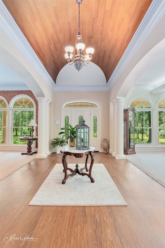 3669 Fountainbleau Rd, Keithville, LA 71047 - foyer with ornate columns, vaulted ceiling, a chandelier, wood ceiling, and arched walkways
