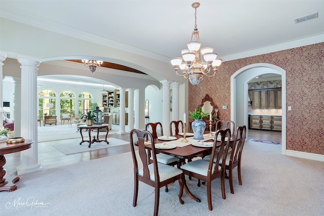 3669 Fountainbleau Rd, Keithville, LA 71047 - dining area featuring arched walkways, a chandelier, crown molding, decorative columns, and wallpapered walls