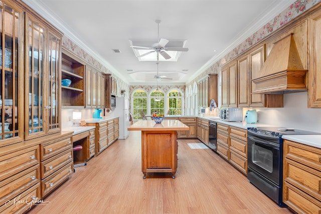 3669 Fountainbleau Rd, Keithville, LA 71047 - kitchen with black appliances, premium range hood, light wood finished floors, light countertops, and crown molding