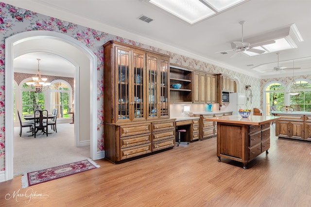 3669 Fountainbleau Rd, Keithville, LA 71047 - kitchen featuring wallpapered walls, light countertops, arched walkways, a ceiling fan, and healthy amount of natural light