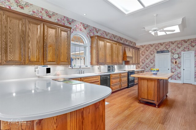 3669 Fountainbleau Rd, Keithville, LA 71047 - kitchen featuring wallpapered walls, black appliances, light wood-style flooring, light countertops, and crown molding