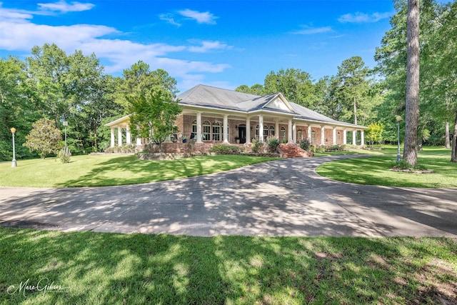 3669 Fountainbleau Rd, Keithville, LA 71047 - neoclassical home with covered porch, a front lawn, and brick siding