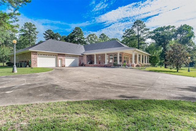 3669 Fountainbleau Rd, Keithville, LA 71047 - view of front facade featuring driveway, a front yard, an attached garage, brick siding, and covered porch