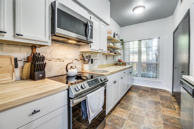 2407 Northlake Ct, Irving, TX 75038 - kitchen with appliances with stainless steel finishes, butcher block counters, decorative backsplash, white cabinetry, and open shelves
