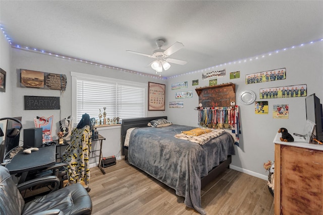 631 N Robinson Dr, Robinson, TX 76706 - bedroom featuring light wood-style flooring, a textured ceiling, an office area, and ceiling fan