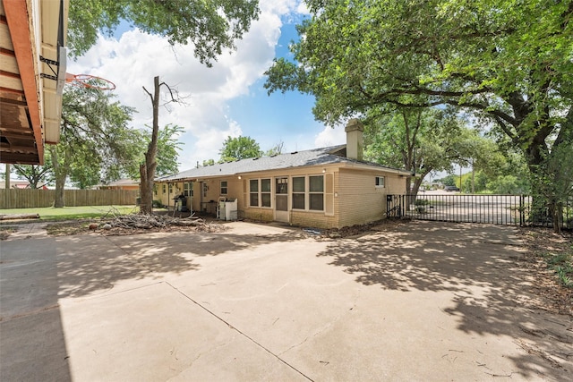 631 N Robinson Dr, Robinson, TX 76706 - back of property with a chimney, a patio area, and brick siding