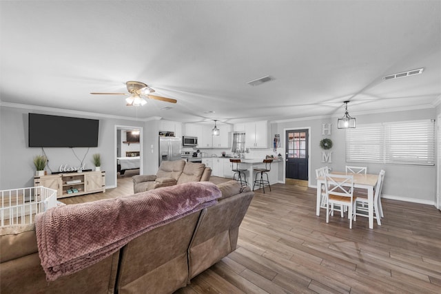 631 N Robinson Dr, Robinson, TX 76706 - living area featuring ceiling fan, crown molding, and light wood finished floors