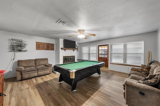 631 N Robinson Dr, Robinson, TX 76706 - game room with a ceiling fan, light wood-style floors, pool table, a textured ceiling, and a glass covered fireplace