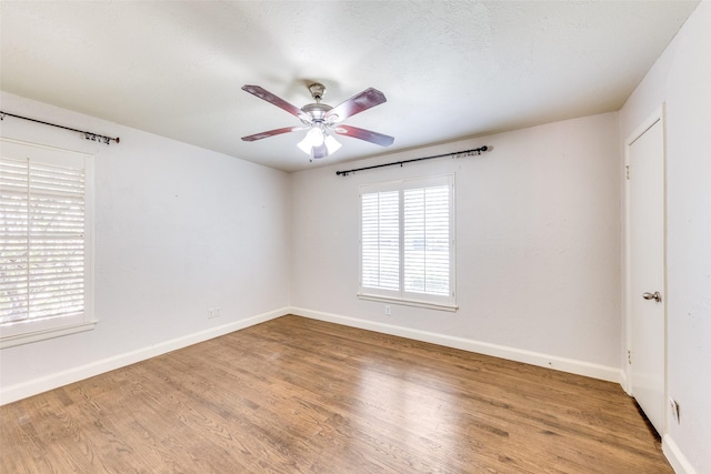 6823 Walnut Hill Ln, Dallas, TX 75230 - spare room with plenty of natural light, wood finished floors, and ceiling fan