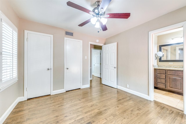 6823 Walnut Hill Ln, Dallas, TX 75230 - unfurnished bedroom featuring light wood-style flooring, ensuite bath, and a ceiling fan