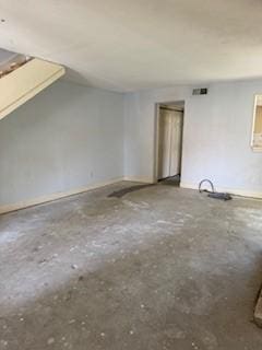733 Intrepid Dr, Garland, TX 75043 - spare room with vaulted ceiling and concrete flooring