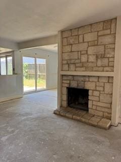 733 Intrepid Dr, Garland, TX 75043 - unfurnished living room with a stone fireplace and unfinished concrete floors