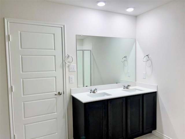 255 Carolina Trce, Fate, TX 75189 - bathroom with double vanity and a shower with shower door