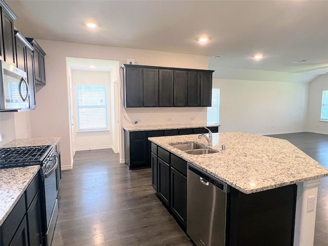 255 Carolina Trce, Fate, TX 75189 - kitchen with appliances with stainless steel finishes, dark wood finished floors, light stone counters, a center island with sink, and recessed lighting