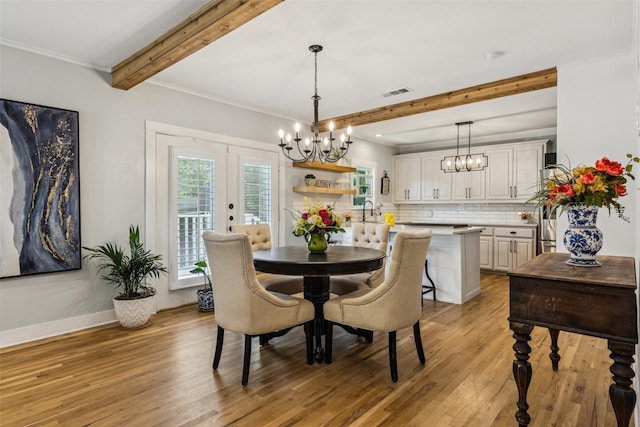 919 S Tennessee St, Mckinney, TX 75069 - dining space featuring a chandelier, beamed ceiling, light wood-style floors, french doors, and crown molding