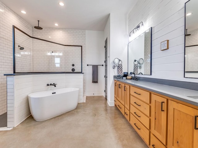 641 Cox Rd, Waxahachie, TX 75167 - bathroom with tiled shower, double vanity, a freestanding bath, concrete flooring, and recessed lighting