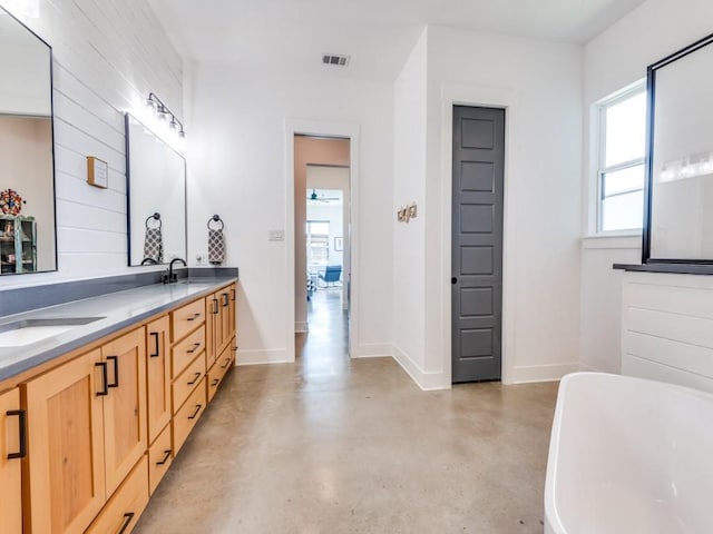 641 Cox Rd, Waxahachie, TX 75167 - bathroom with a soaking tub, double vanity, and concrete floors