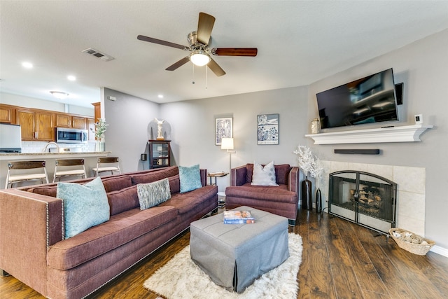 2019 Mcbroom St, Dallas, TX 75212 - living area featuring dark wood-style floors, ceiling fan, a tiled fireplace, and recessed lighting
