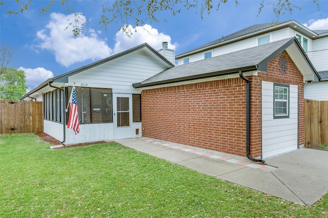 2019 Mcbroom St, Dallas, TX 75212 - rear view of house featuring brick siding, a sunroom, a chimney, and a shingled roof