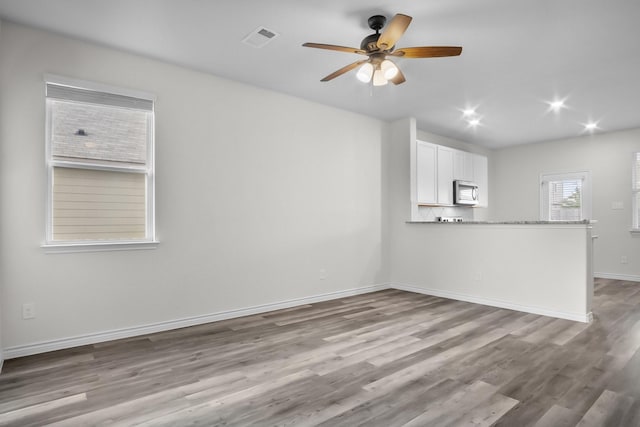 8313 White Pine Dr, Fort Worth, TX 76123 - unfurnished living room featuring a ceiling fan, wood finished floors, and recessed lighting
