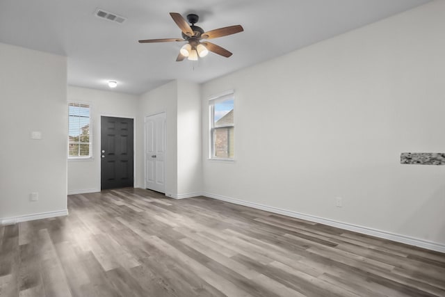8313 White Pine Dr, Fort Worth, TX 76123 - empty room featuring healthy amount of natural light, a ceiling fan, and wood finished floors
