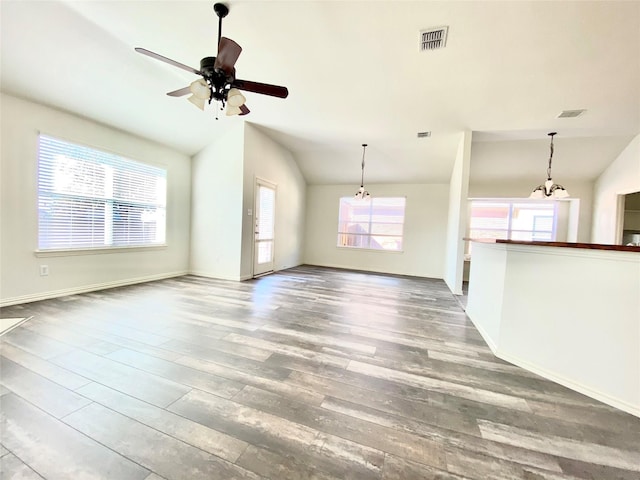 2717 Lumina Dr, Little Elm, TX 75068 - unfurnished living room featuring vaulted ceiling, wood finished floors, ceiling fan, and a chandelier