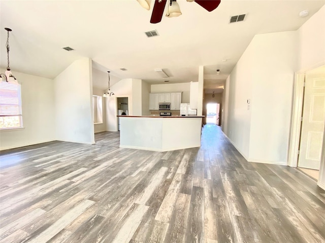 2717 Lumina Dr, Little Elm, TX 75068 - unfurnished living room featuring ceiling fan, wood finished floors, and vaulted ceiling
