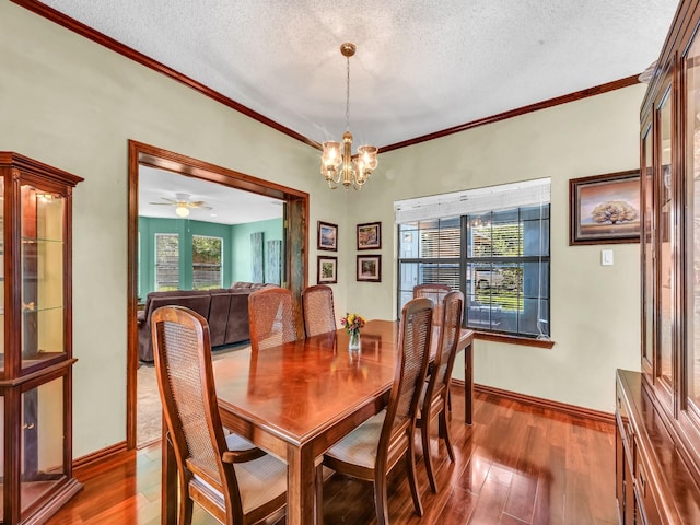 3502 Stage Coach Trl, Weatherford, TX 76087 - dining space featuring plenty of natural light, a textured ceiling, hardwood / wood-style flooring, ornamental molding, and a chandelier