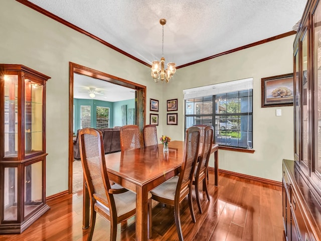3502 Stage Coach Trl, Weatherford, TX 76087 - dining space featuring hardwood / wood-style floors, plenty of natural light, a textured ceiling, a chandelier, and ornamental molding