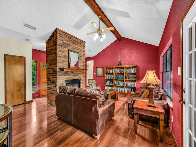 3502 Stage Coach Trl, Weatherford, TX 76087 - living area featuring hardwood / wood-style floors, a fireplace, a textured ceiling, and ceiling fan