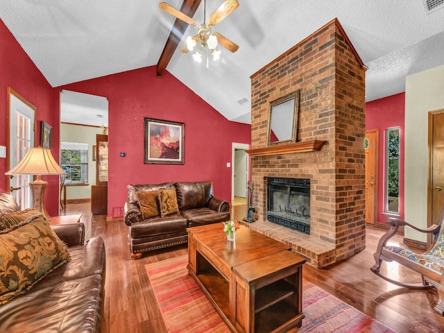 3502 Stage Coach Trl, Weatherford, TX 76087 - living room featuring ceiling fan, hardwood / wood-style floors, a fireplace, and a textured ceiling