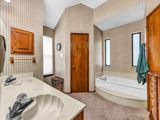 3502 Stage Coach Trl, Weatherford, TX 76087 - bathroom featuring lofted ceiling, double vanity, a bath, and wallpapered walls