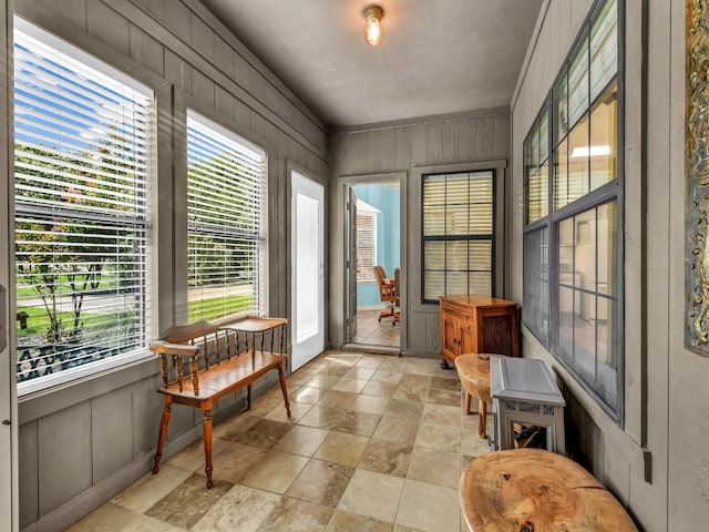 3502 Stage Coach Trl, Weatherford, TX 76087 - sunroom featuring healthy amount of natural light, wooden walls, and stone finish flooring