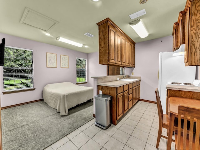 3502 Stage Coach Trl, Weatherford, TX 76087 - kitchen with healthy amount of natural light, brown cabinets, light countertops, and recessed lighting